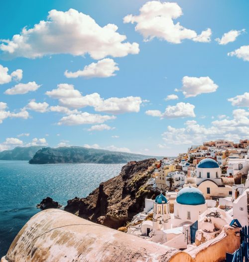 Captivating view of Santorini's famous blue-domed buildings under a vibrant sky.