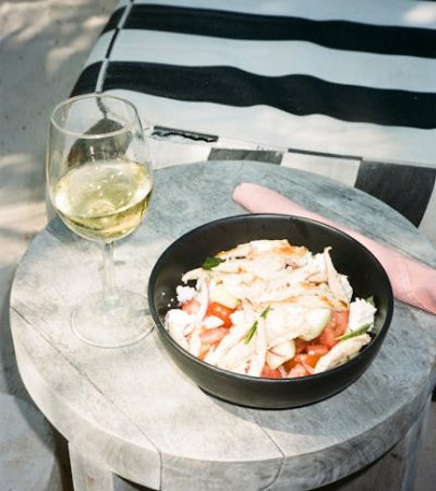 pexels-photo-29837392-29837392 Delicious chicken salad and wine on a sunny day in Tulum, Mexico.