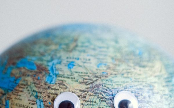 Model of globe with googly eyes representing Earth as character with need of protection