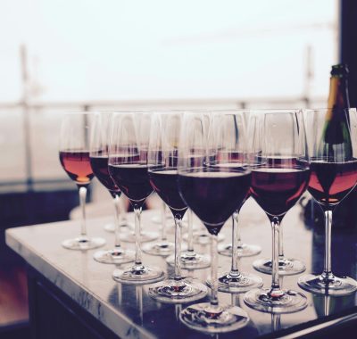 A collection of red wine glasses elegantly arranged on a bar table, perfect for events.